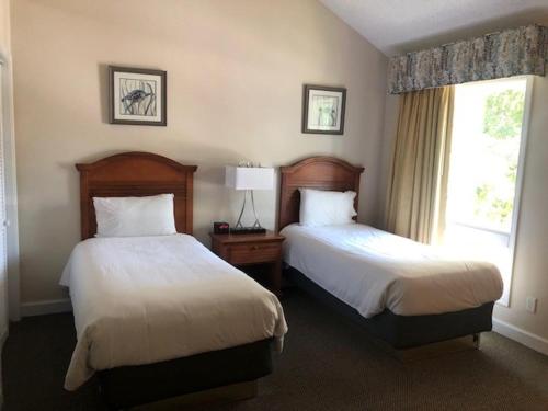 a hotel room with two beds and a window at The Links in Myrtle Beach