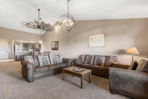 a living room with two couches and a table at Table Rock Resorts at Indian Point in Branson