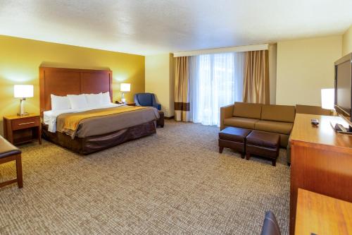 a hotel room with a bed and a couch at Comfort Inn Salt Lake City Downtown in Salt Lake City