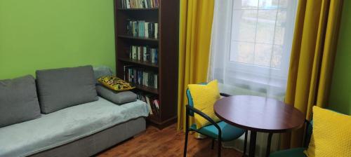 a living room with a couch and a table at Agroturystyka Przystanek Góry Sowie in Ludwikowice Kłodzkie