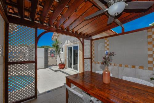 a dining room with a table and a ceiling fan at Boutique Hotel Swiss Paradise Aruba Villas and Suites in Palm-Eagle Beach