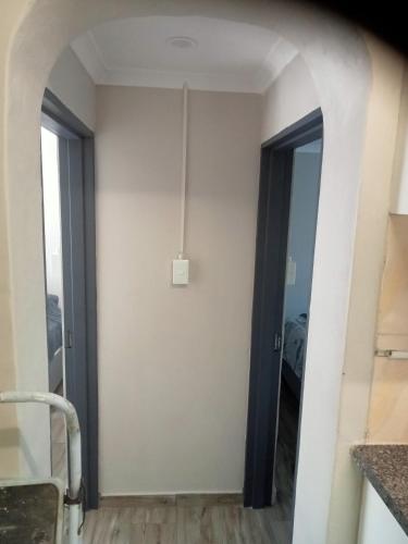 a hallway with a door open to a room at eagles inn in Richards Bay