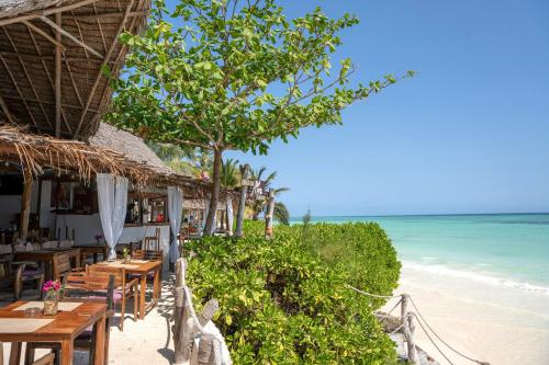 a restaurant on the beach with a view of the ocean at Aya Beach Resort in Kizimkazi