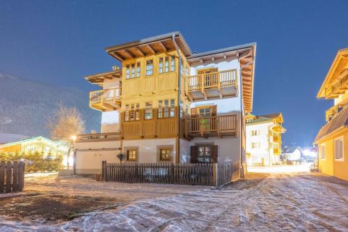 a large wooden building with a balcony at Cesa Meida 2B in Pozza di Fassa