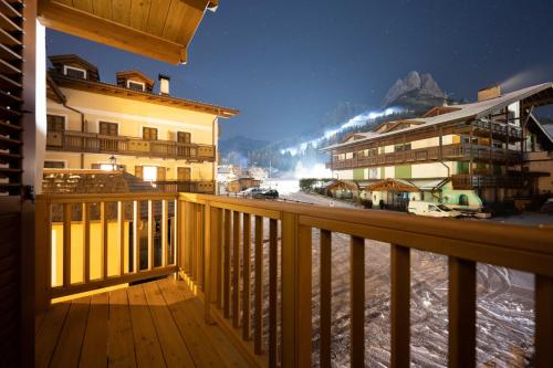 a balcony of a building with snow on the ground at Cesa Meida 2B in Pozza di Fassa
