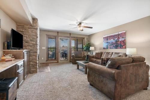 a living room with a couch and a tv at Table Rock Resorts at Indian Point in Branson