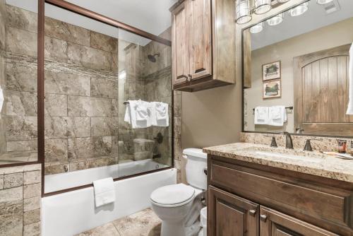 a bathroom with a toilet and a shower and a sink at Table Rock Resorts at Indian Point in Branson