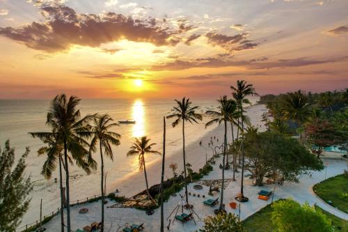 a view of the beach and the ocean at sunset at Aya Beach Resort in Kizimkazi