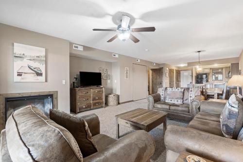 a living room with furniture and a ceiling fan at Table Rock Resorts at Indian Point in Branson