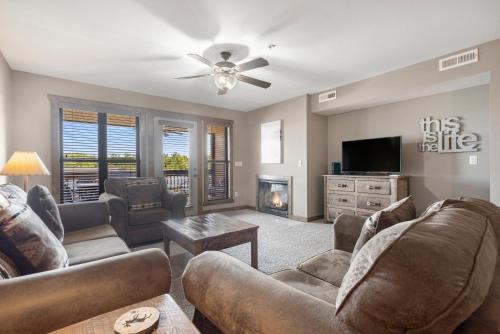 a living room with couches and a tv and a fireplace at Table Rock Resorts at Indian Point in Branson