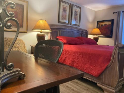 a bedroom with a bed and a table with a red blanket at Spacious 3 Bedroom 2 bath Condo close to Five-points in Athens in Athens