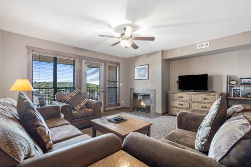 a living room with a couch and a fireplace at Table Rock Resorts at Indian Point in Branson