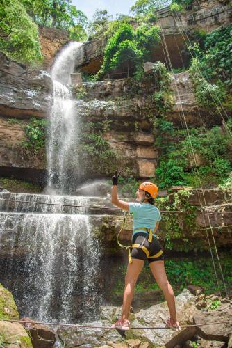 a woman standing in front of a waterfall at Real Dream Hostel in San Gil