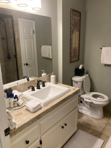 a bathroom with a sink and a toilet at Spacious 3 Bedroom 2 bath Condo close to Five-points in Athens in Athens