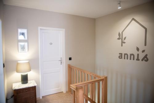 a room with a staircase with a door and a lamp at Das Anni's in Wangerland