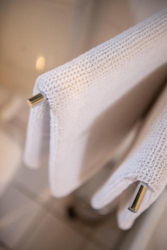 two white towels on a sink in a bathroom at Das Anni's in Wangerland