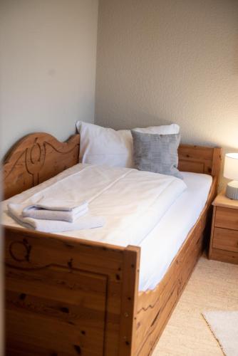 a bed with a wooden frame with a book on it at Das Anni's in Wangerland