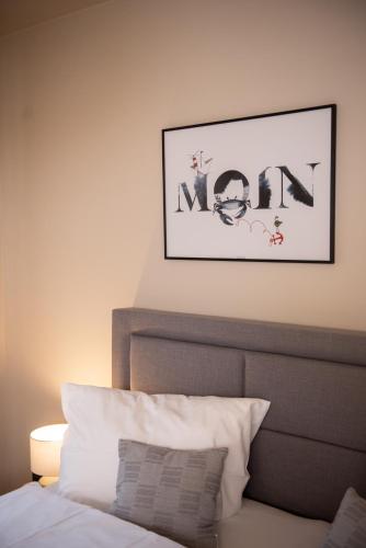 a bedroom with a bed and a picture on the wall at Das Anni's in Wangerland