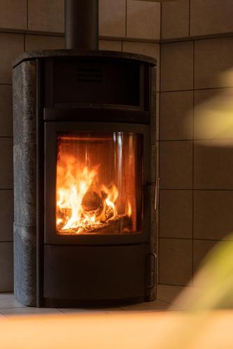 a brick oven with a fire in it at Das Anni's in Wangerland