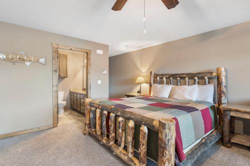 a bedroom with a wooden bed and a bathroom at Table Rock Resorts at Indian Point in Branson