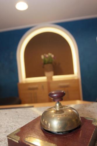 a bell sitting on top of a table with a door at Altstadt-Hotel Passau in Passau