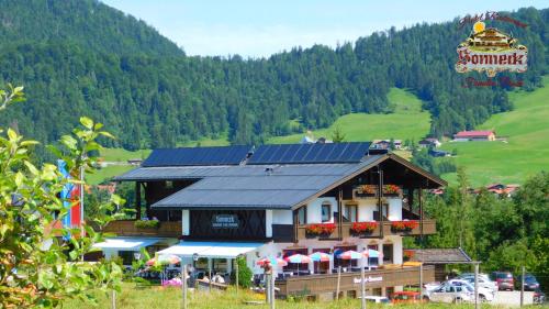a building with solar panels on top of it at Hotel-Gasthof-Sonneck in Reit im Winkl