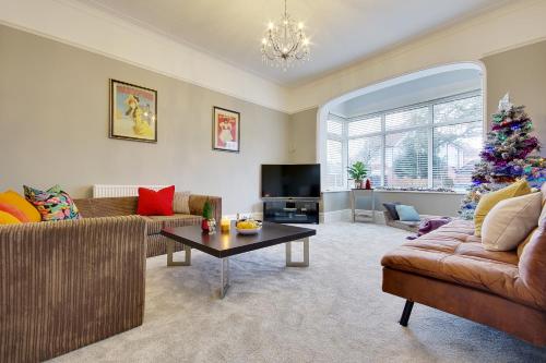 a living room with a christmas tree in it at Beach Way House in Southbourne