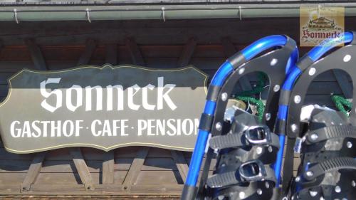 a sign for a store with a sign for a gym at Hotel-Gasthof-Sonneck in Reit im Winkl