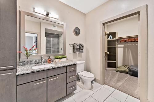 a bathroom with a sink and a toilet and a shower at Modern & Chic 1BR Luxury Apts Close to Downtown & Airport in Austin