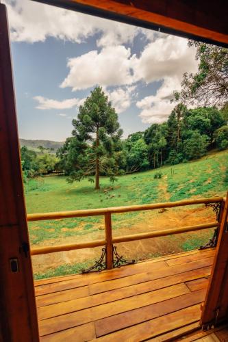 a view of a field from a porch at Montanha Home in Monte Verde