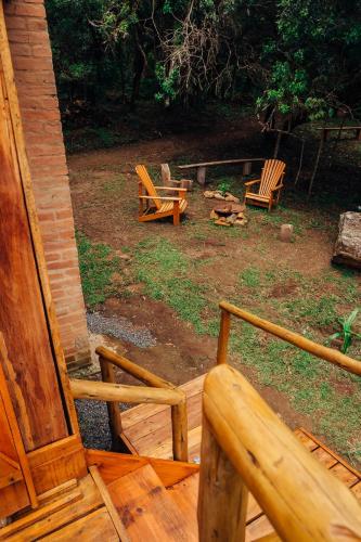 a couple of chairs sitting on a porch at Montanha Home in Monte Verde