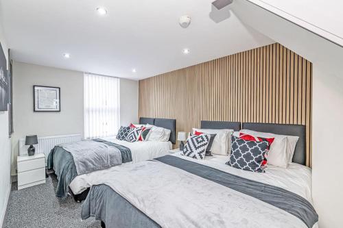 a bedroom with two beds with pillows on them at Accommodation for Liverpool Football in Liverpool