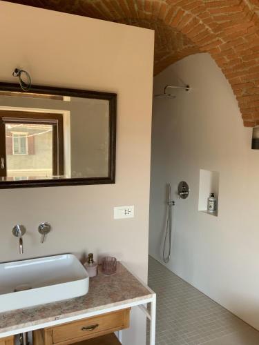 a bathroom with a sink and a mirror at Appartamento Biò in Borgofranco dʼIvrea
