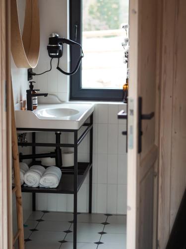 a bathroom with a sink and a mirror at Owczarnia Tatry in Bukowina Tatrzańska