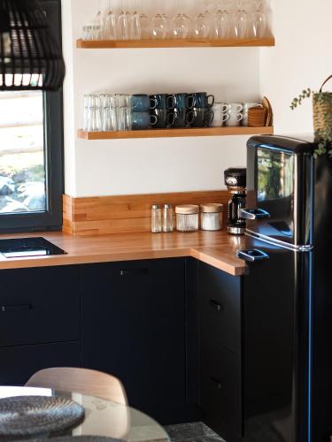 a kitchen with a wooden counter and a refrigerator at Owczarnia Tatry in Bukowina Tatrzańska