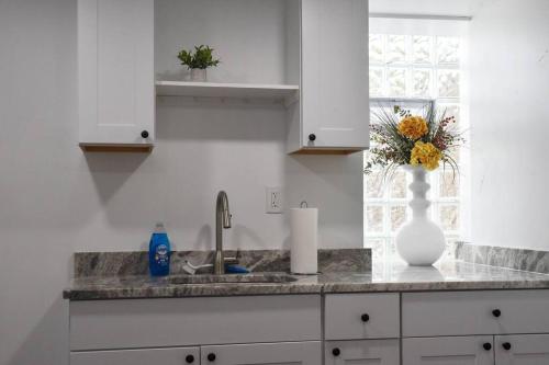 a kitchen with a sink and a vase on the counter at Cozy Mount Washington Home with Parking-Sleeps 4 in Pittsburgh