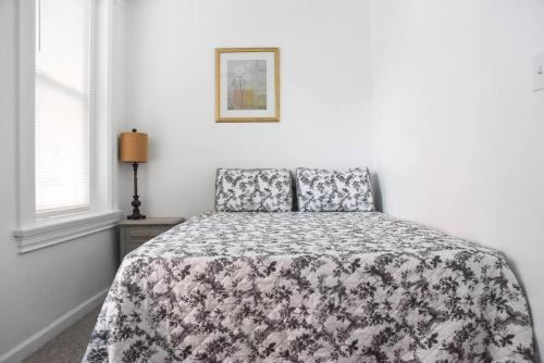 a bedroom with a bed with a floral bedspread at Perfect Mount Washington Home Walkable w Parking in Pittsburgh