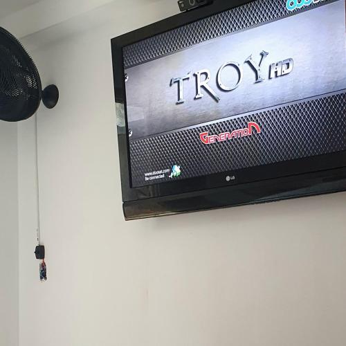 a flat screen tv on a wall at Royal-inn SPA & Pousada in Itanhaém