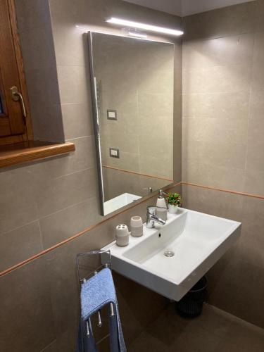 a bathroom with a white sink and a mirror at Casale Riorso in Orvieto