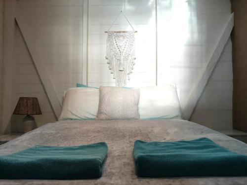 a bedroom with a bed and a chandelier at Santuarios del Mar in Bocas del Toro