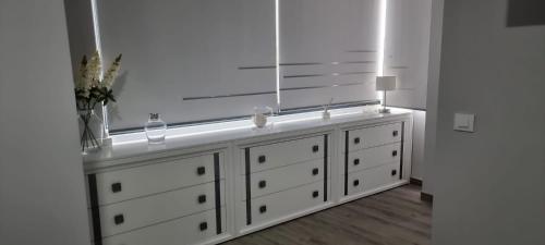 a white dresser with a mirror on top of it at Virrey del Pino - Apartamento en Baena in Baena