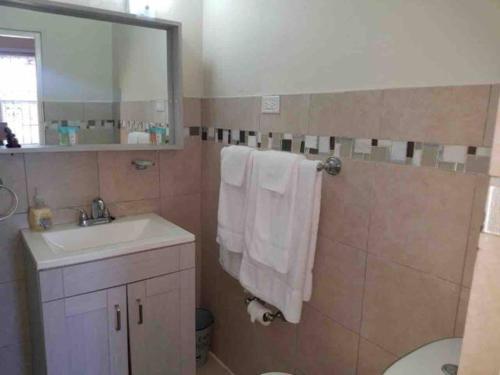 a bathroom with a sink and a toilet and a mirror at Bella Vista Vacation in Montego Bay