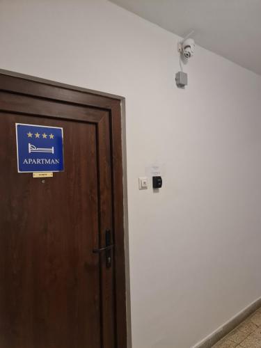 a door with a sign that reads american at Apartment Pemper - Self check in and check out in Otočac