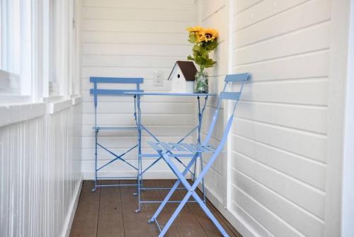 a blue table with a bird house and a vase of flowers at Perfect Pittsburgh Home Close To City & Airport in Pittsburgh