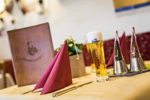 a table topped with trophies and a bottle of beer at Ferienhotel Gewürzmühle in Radstadt