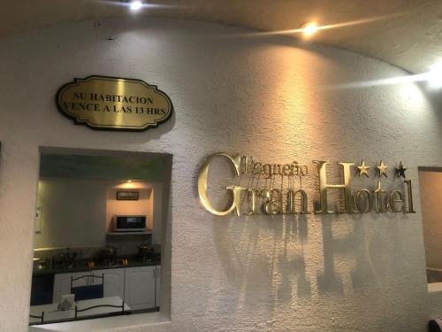 a room with signs on the wall of a hotel at Pequeno Gran Hotel in Aguascalientes
