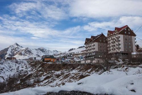 a large building on top of a snowy mountain at Apartment in Gudauri in Gudauri