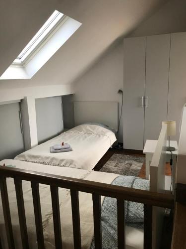 a bedroom with a bed and a skylight at Centrum in Belgrade