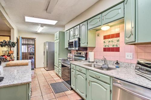 a kitchen with green cabinets and a sink at Rio Rancho Home Less Than 14 Mi Old Town Albuquerque! in Rio Rancho
