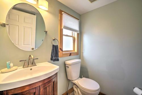 a bathroom with a sink and a toilet and a mirror at Jersey Apt - half Mi to Seaside Heights Beach in Seaside Heights